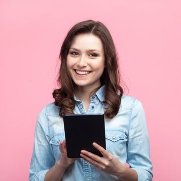 cheerful-girl-using-tablet-on-pink-2022-11-03-19-12-21-utc-min